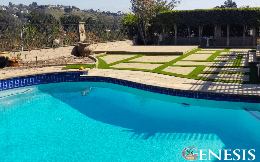 Genesis Stoneworks pool deck landscaping featuring artificial grass as a decorative border around patio pavers.