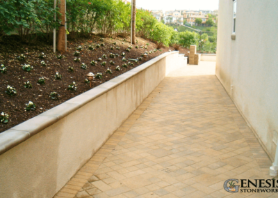 Genesis Stoneworks Stucco Retaining Wall with Precast Cap & Paver Side Yard